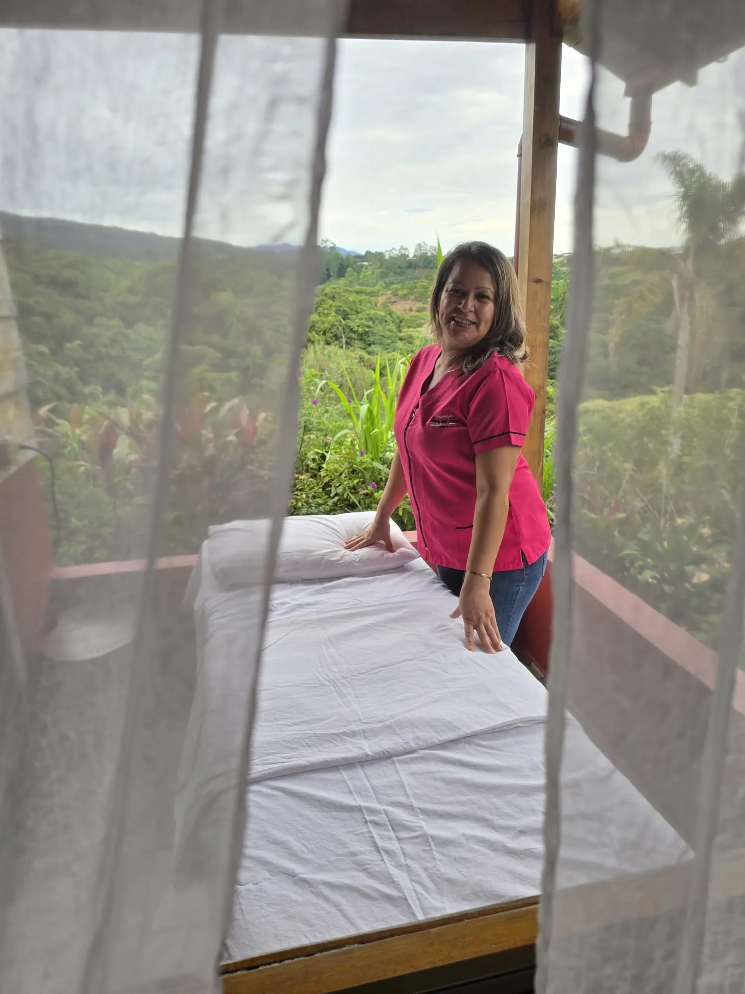 Therapist with outdoor massage table overlooking the forest at Mango Valley