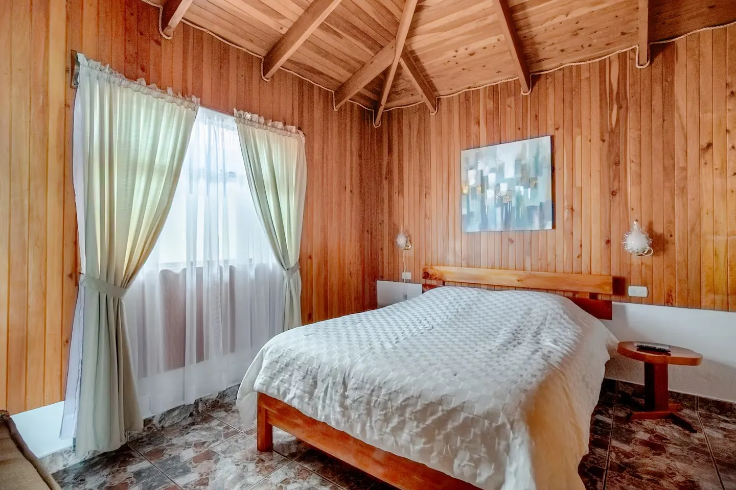 Poas Cottage queen bedroom with vaulted wood ceiling
